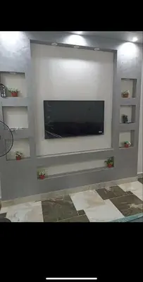 a living room with a flat screen tv on a wall at Dream Apartment 4 in Hurghada