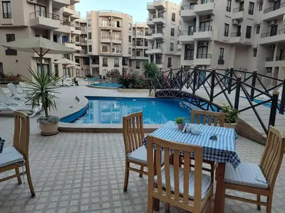 a patio with a table and chairs next to a pool at Apartmant for family in Hurghada in Hurghada