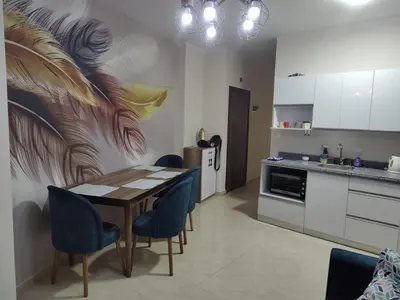a kitchen with a table and blue chairs in a room at Apartmant for family in Hurghada in Hurghada