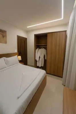 a bedroom with a large bed and a closet at Diva Suites in Hurghada