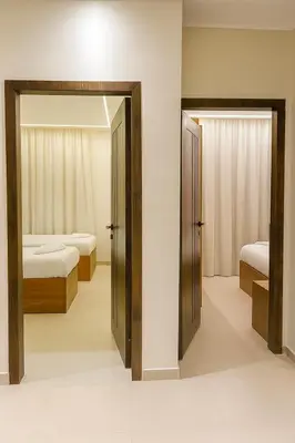 a bedroom with two beds and a mirror at Diva Suites in Hurghada