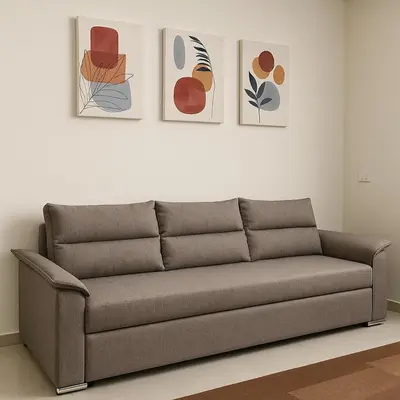 a couch in a living room with paintings on the wall at Diva Suites in Hurghada