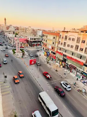 a busy city street filled with cars and buses at Diva Suites in Hurghada