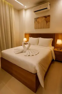 a bedroom with a bed with two swans on it at Diva Suites in Hurghada