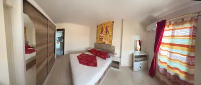 a room with two beds with red pillows at طيبة جولد Tiba Gold in Hurghada