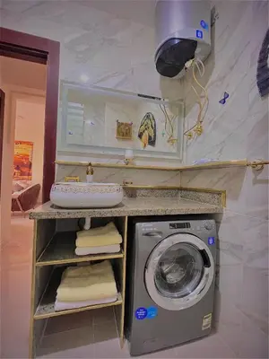 a bathroom with a washing machine and a sink at طيبة جولد Tiba Gold in Hurghada