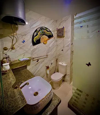 a bathroom with a white toilet and a sink at طيبة جولد Tiba Gold in Hurghada