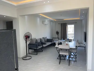 a living room with a couch and a table at Panorama View Sahl Hashesh Luxury Suite in Hurghada