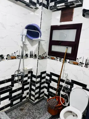 a bathroom with a black and white tiled wall at شقه في ميدان العروسه in Hurghada