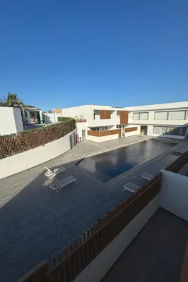 a swimming pool on the roof of a building at Sunny Escape 1BR with Pool Access in Hurghada