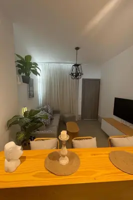 a living room with a table and a couch at Sunny Escape 1BR with Pool Access in Hurghada