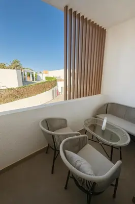 a room with two tables and chairs and a window at Sunny Escape 1BR with Pool Access in Hurghada