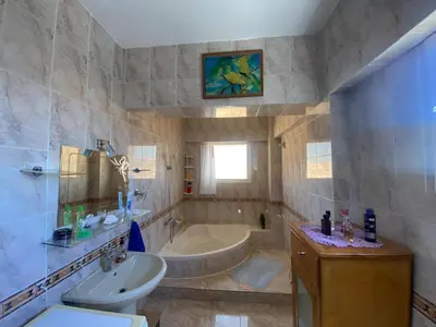 a bathroom with a tub and a sink and a toilet at Jana in Hurghada