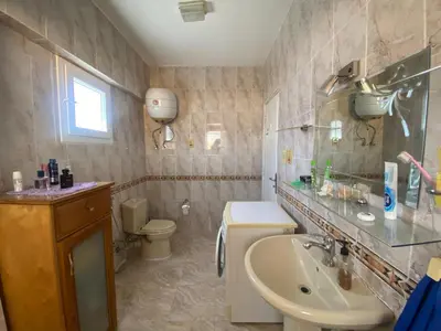 a bathroom with a sink and a toilet and a sink at Jana in Hurghada
