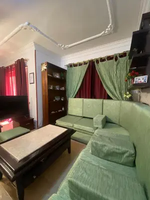 a living room with green furniture and a couch at Jana in Hurghada