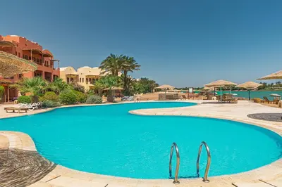 a large blue swimming pool in a resort at Peaceful Oasis, Stunning Views and Refreshing Pool, El Gouna in Hurghada