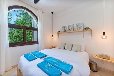 a bedroom with a bed with blue towels on it at Peaceful Oasis, Stunning Views and Refreshing Pool, El Gouna in Hurghada