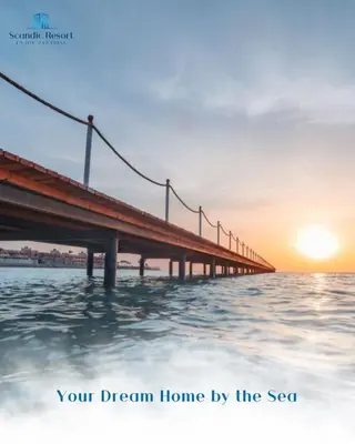 a bridge over the water with the sunset in the background at Scandic resort in Hurghada