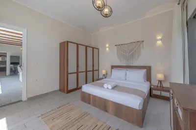 a bedroom with a large bed and a bathroom at Lovely 2BR with Private Pool in Bali El Gouna in Hurghada