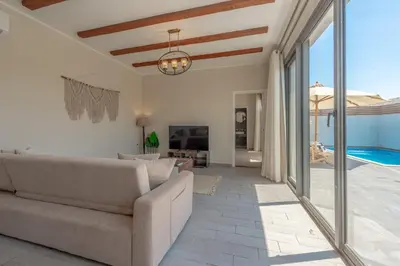 a living room with a couch and a pool at Lovely 2BR with Private Pool in Bali El Gouna in Hurghada