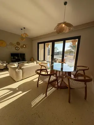 a living room with a table and chairs and a couch at Fanadir Marina 3bedroom private pool in Hurghada
