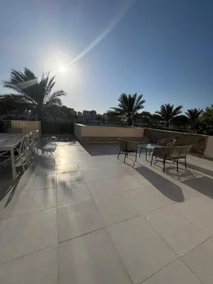 a patio with a table and chairs and the sun at Fanadir Marina 3bedroom private pool in Hurghada