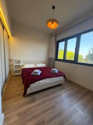 a bedroom with a bed and a large window at Fanadir Marina 3bedroom private pool in Hurghada