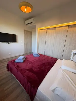 a bedroom with a large bed with a red blanket at Fanadir Marina 3bedroom private pool in Hurghada