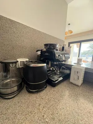 a kitchen counter with a coffee maker and pots and pans at Fanadir Marina 3bedroom private pool in Hurghada