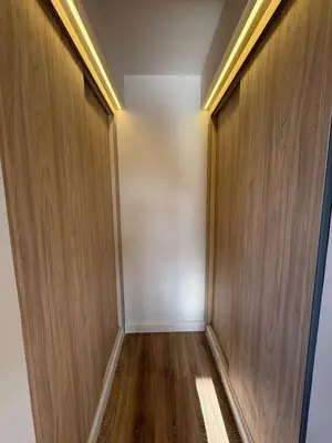 an empty corridor with wooden doors in a building at Fanadir Marina 3bedroom private pool in Hurghada