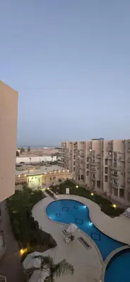 a view of a large apartment complex with a swimming pool at Princess Resort hurghada in Hurghada