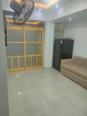 a living room with a couch and a fan at كمبوند كابتن in Hurghada