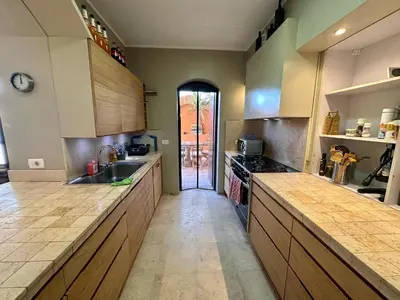 a large kitchen with wooden cabinets and a sink at El Gouna Nubian Lagoonfront Villa - 4BR, 9 Guests in El Gouna