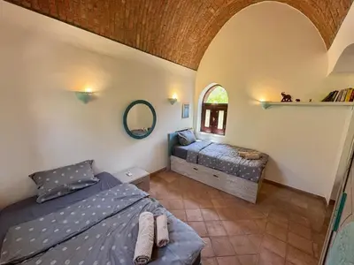 a bedroom with a bed and a mirror at El Gouna Nubian Lagoonfront Villa - 4BR, 9 Guests in El Gouna