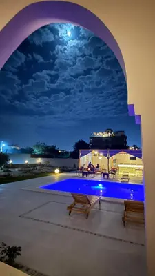 a view of a swimming pool at night at Magic Garden House in Luxor
