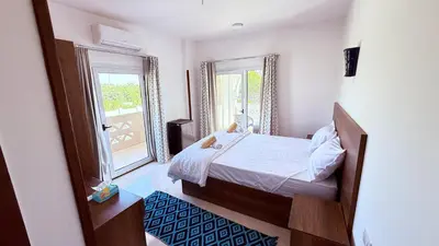 a small bedroom with a bed and a window at Magic Garden House in Luxor