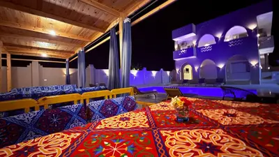 a room with a table with chairs and a table cloth at Magic Garden House in Luxor
