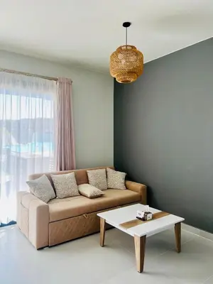 a living room with a couch and a coffee table at Makadi Heights Luxury 1-BR App with Garden & Lagoon View in Hurghada