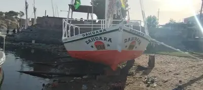 a boat sitting on the shore of a body of water at دندرة بوت in Aswān