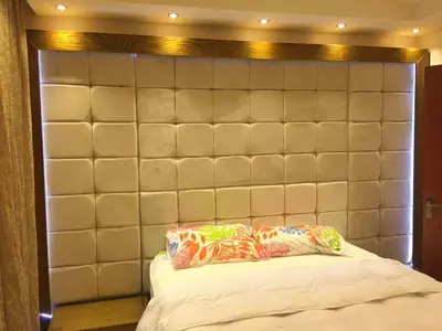 a padded headboard with two pillows on a bed at The view in Hurghada
