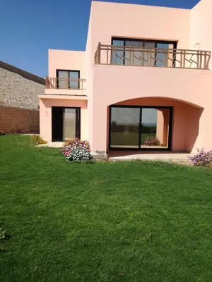a house with a green lawn in front of it at The view in Hurghada