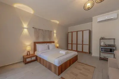 a bedroom with a large bed and a living room at Soulful Studio in Bali El Gouna in Hurghada