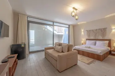 a hotel room with a bed and a couch at Soulful Studio in Bali El Gouna in Hurghada