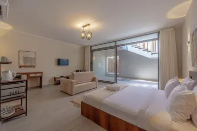 a bedroom with a large bed and a living room at Soulful Studio in Bali El Gouna in Hurghada