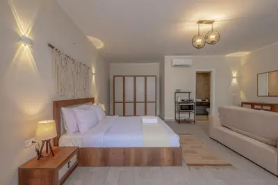 a bedroom with a large bed and a couch at Soulful Studio in Bali El Gouna in Hurghada