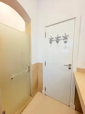 a white door in a room with a counter at El Gouna Stylish 2BR Italian Compound Beach Access in Hurghada