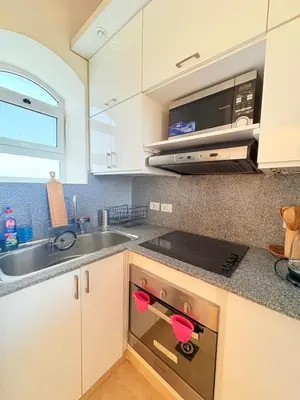 a kitchen with a sink and a stove top oven at El Gouna Stylish 2BR Italian Compound Beach Access in Hurghada