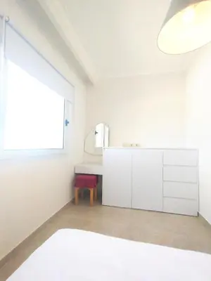 a white room with a table and a window at Bay breeze in Hurghada