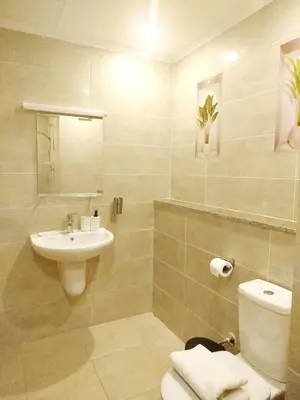 a white bathroom with a sink and a toilet at Bay breeze in Hurghada