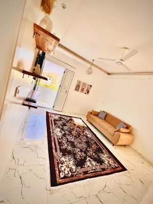 a living room with a couch and a rug at Muhammad Ali house in Luxor
